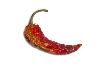 Dried red pepper on a white background. Ingredient for dishes. Spice concept. Wrinkled chili pepper.
