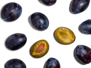 Plums on a white background. Juicy sliced plum. Stone in yellow pulp. Healthy food concept. Sweet purple variety. Fruit on the table.