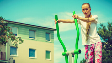 Girl exercise at outdoor gym area