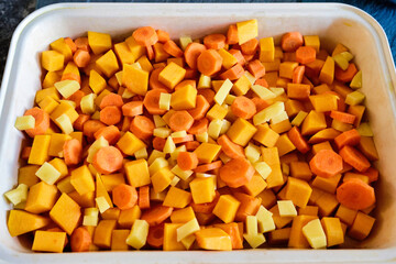 chopped carrots, potatoes and pumpkin in a baking dish
