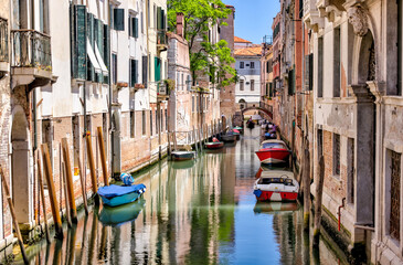 Fototapeta na wymiar Venice, Italy - July 5, 2022: Building exteriors along the canals in Venice Italy 