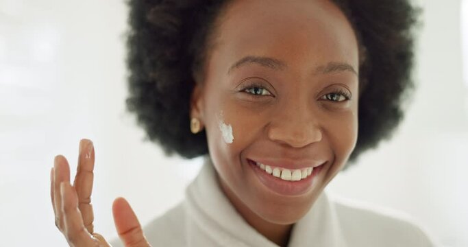 Black woman face, skincare and cream in happiness for smooth, soft and fresh skin at home. Happy African female with smile and afro in healthy cosmetics and touching face with moisturizer or lotion