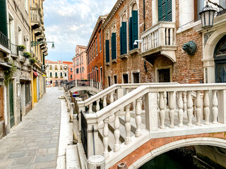Fototapeta na wymiar Venice, Italy - July 5, 2022: Building exteriors along the canals in Venice Italy 