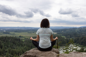 Fototapeta na wymiar Adventurous Woman in Meditation overlooking the Canadian Nature Landscape.