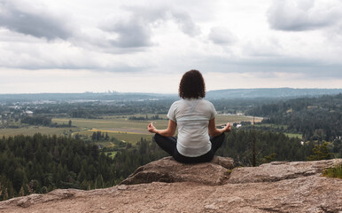 Naklejka na ściany i meble Adventurous Woman in Meditation overlooking the Canadian Nature Landscape.