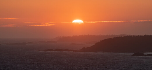 Waves on the Pacific Ocean on a rocky beach. West Coast. Sunny Summer Sunset.