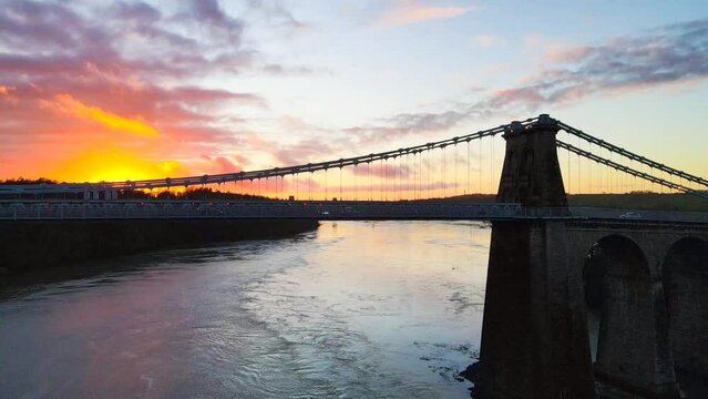 Dramatic sunset backdrop to Menai suspension bridge, Menai Straits, Anglesey, Wales