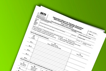 Form 8870 documentation published IRS USA 10.26.2021. American tax document on colored