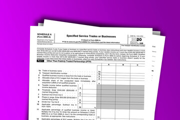 Obraz premium Form 8995-A (Schedule A) documentation published IRS USA 01.26.2021. American tax document on colored