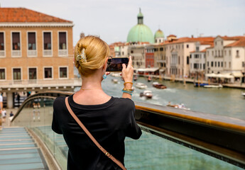 Fototapeta na wymiar Woman taking a photo in Venice Italy 