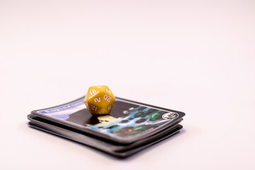 a yellow Role play game dice over some monster cards