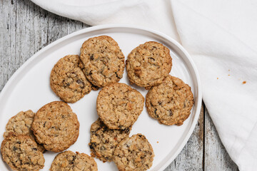 Freshly baked müsli and oatmeal raisin cookies, traditional American biscuits made of flour, rolled oats, oat meal, muesli, sugar, eggs, raisins or sultanas and baking soda or powder, chewy and soft - 531552628