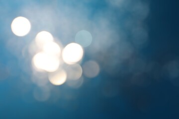 Shiny blue background with magical bokeh effect