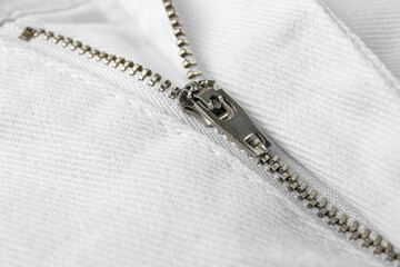 White jacket with zipper as background, closeup view
