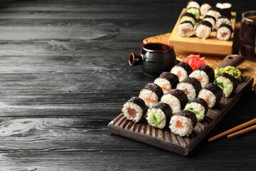Tasty sushi rolls served on black wooden table. Space for text © New Africa