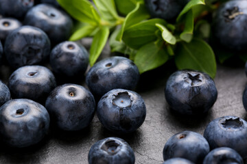 Tasty fresh blueberries on grey table, closeup