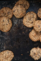 Müsli Oatmeal Cookies with raisins and dried fruits, most popular American biscuit on rustic, vintage baking sheet, selective focus macro shot of traditional home made rolled oats cookies from the USA - 531553057