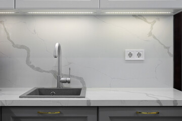 Faucet and granite sink in the kitchen