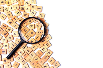 English alphabet made of square wooden tiles with the English alphabet scattered on white...