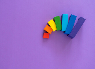 Multicolored abstract rainbow background. Wooden kids toys on violet paper. Educational toys...