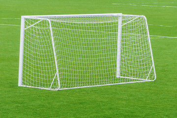 Football gate on the green grass field.