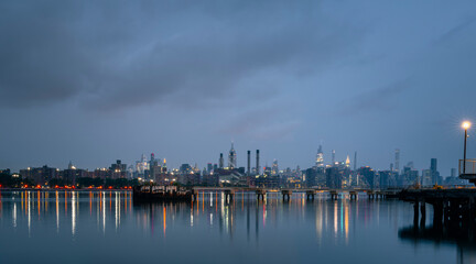 port at night panorama New York City manhattan river water reflections lights sky clouds could 