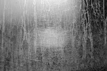 Dried traces of rain texture on glass window with glow