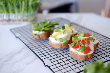 Healthy sandwiches with vegetables and microgreens.