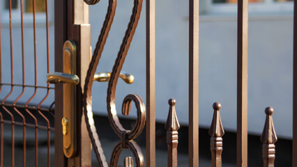 Defocus forged decor of forged elements for metal gates. Forged metal fence in retro style. Gate...