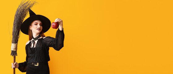 Young witch with apple on yellow background with space for text