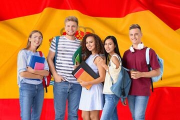 Group of students against flag of Spain - obrazy, fototapety, plakaty
