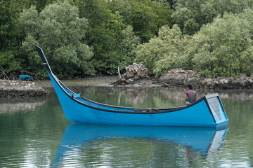 Naklejka na ściany i meble a blue fishing wooden boat