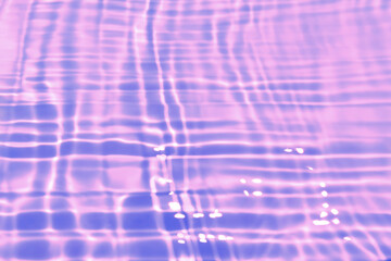 Defocus blurred transparent purple colored clear calm water surface texture with splash, bubble. Shining purple water ripple background. Surface of water in swimming pool. Tropical purple water color.