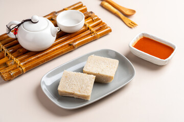 Raw Turnip cake (Chinese : Chai tow kway ). Turnip cake  is a common dish or dim sum of Teochew cuisine in Chaoshan, China usually cut into rectangular slices and sometimes pan-fried before serving.