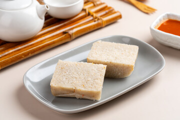 Raw Turnip cake (Chinese : Chai tow kway ). Turnip cake  is a common dish or dim sum of Teochew cuisine in Chaoshan, China usually cut into rectangular slices and sometimes pan-fried before serving.