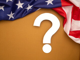 White question mark over a brown background with the American flag on top