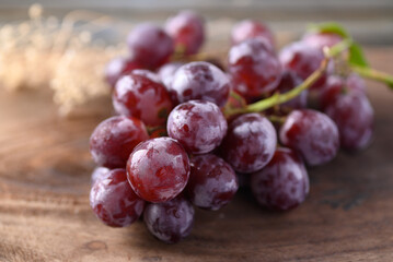 Bunch of red grape on wooden background, healthy fruit