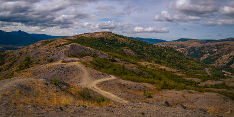 Mt Saint Helens National Volcanic Monument, cloudscape, and curving hilly mountain roads in Washington State in autumn