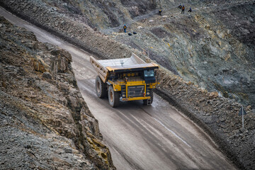Open pit mine industry, big yellow mining truck for coal anthracite.