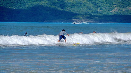 Man surfing in Tamarindo, Costa Rica