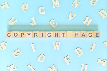 Copyright part of a book concept. Wooden blocks typography word flat lay in blue background