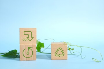Reduce, reuse, recycle and sustainable and environment friendly business, CSR and ESG concept. Hand stacking wooden blocks with environmental conservation icons.