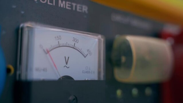 Mechanical voltmeter close up. Voltage measuring device on a gasoline generator. Smooth camera movement. Zero energy production