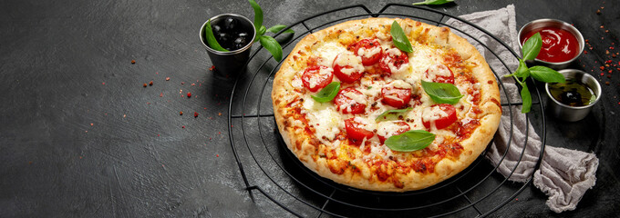 Freshly baked pizza on dark background.
