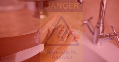 Digital illustration of a person washing hands over a danger hazard sign with a Biological hazard si