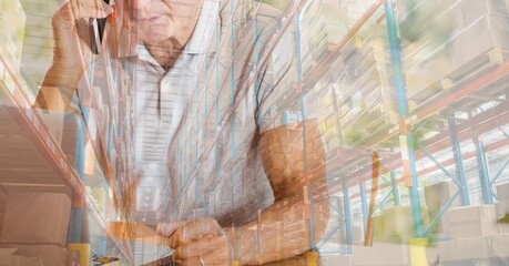 Caucasian man talking on the phone, using laptop and shopping online over warehouse