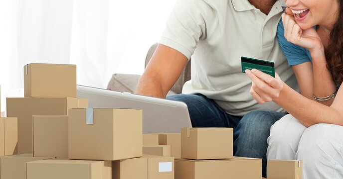 Caucasian man and woman using laptop shopping online and making payment with credit card