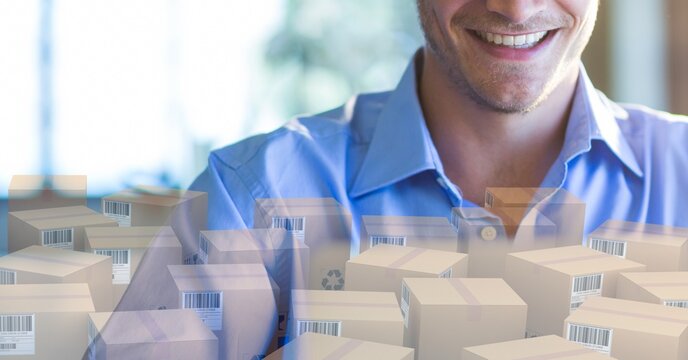 Caucasian man using laptop shopping online with a pile of boxes 
