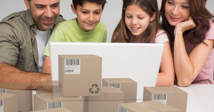Caucasian couple and thier children using laptop shopping online with a pile of boxes