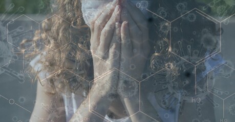 Digital illustration of a woman coughing, covering her face with hands over a chemical element